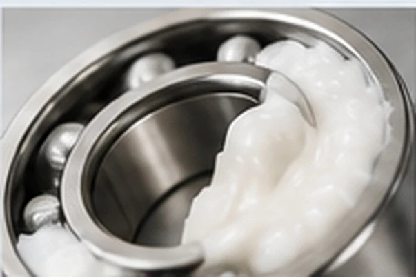 White food grade grease packed into a bearing