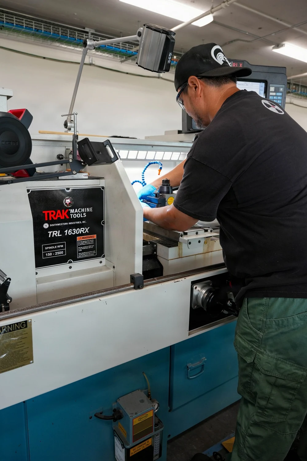 Machinist setting up a CNC machine tool.